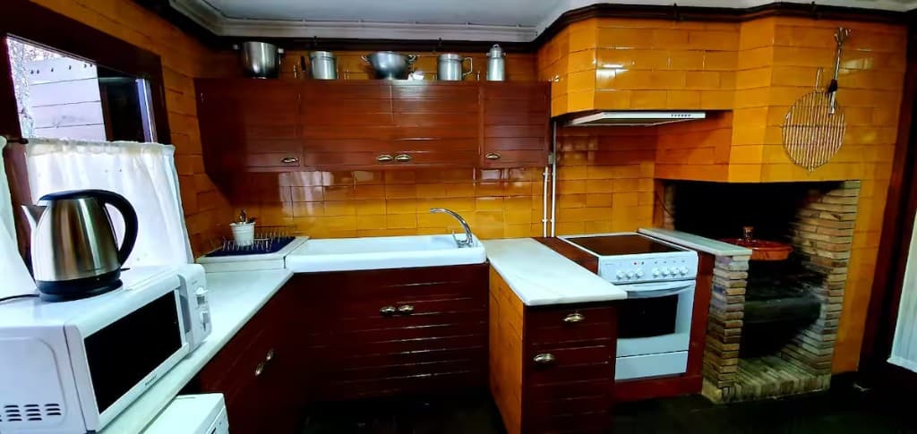 Traditional kitchen with orange tiles and farmhouse sink