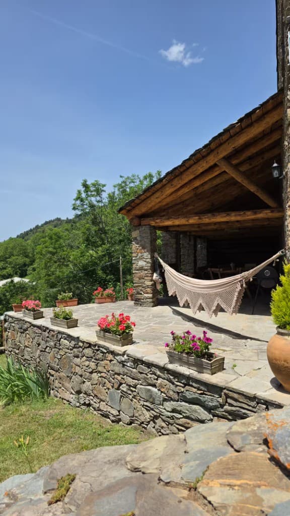 Terrace with flowers looking over green mountains